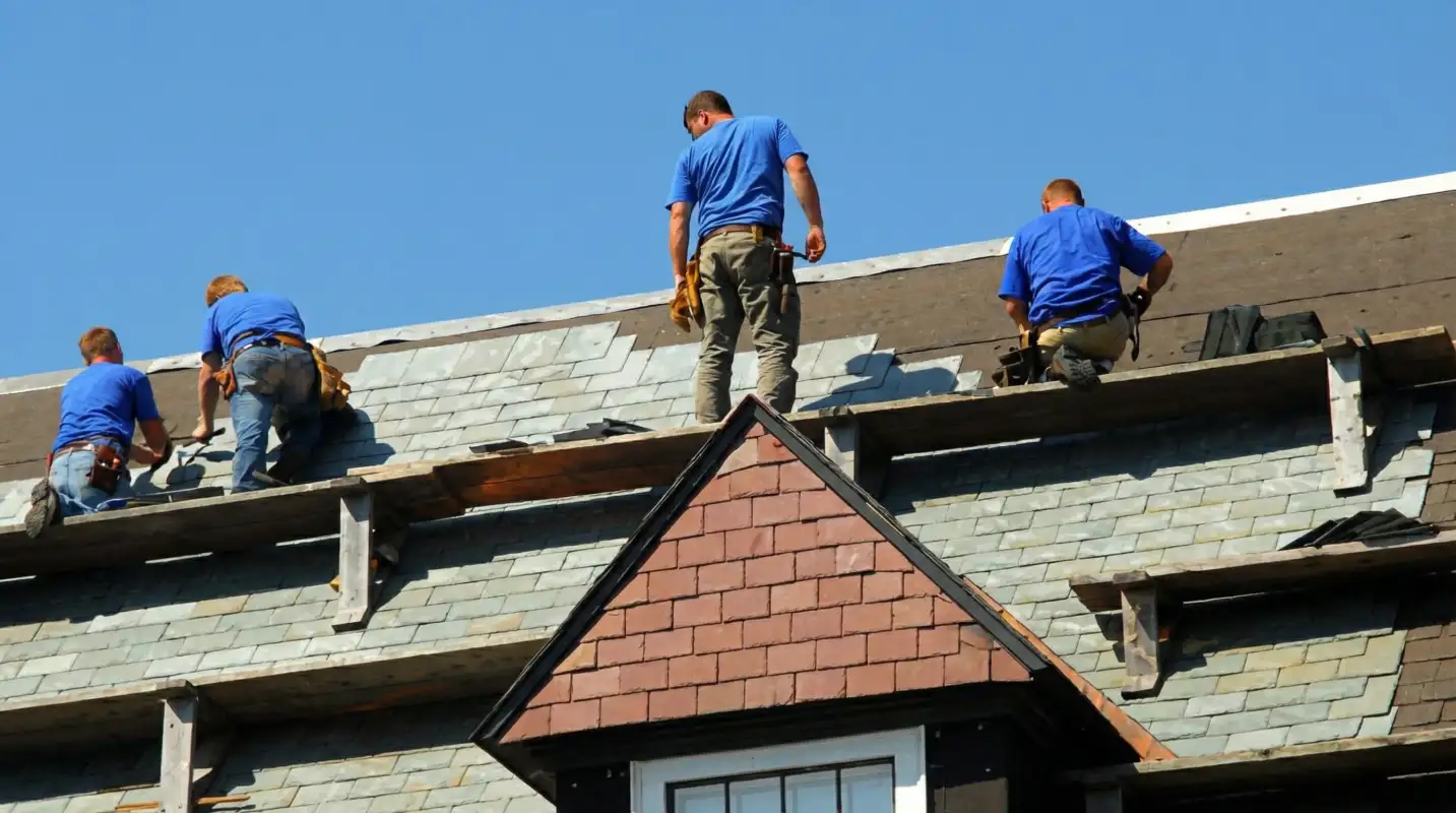 Roof replacement in progress with a team of professional contractors installing new shingles on a residential home in Sioux Falls, SD